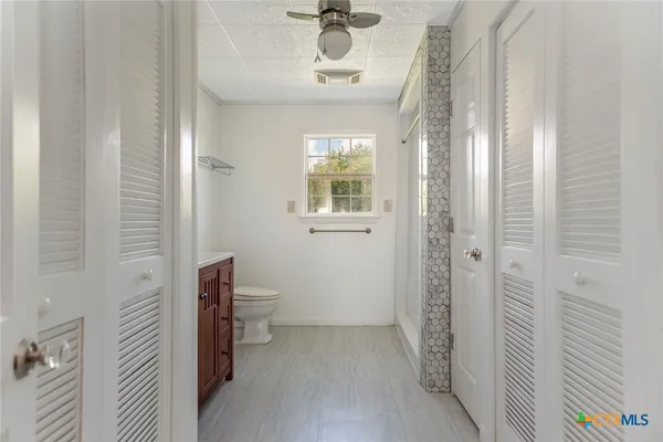 a bathroom with a granite countertop sink a mirror and vanity