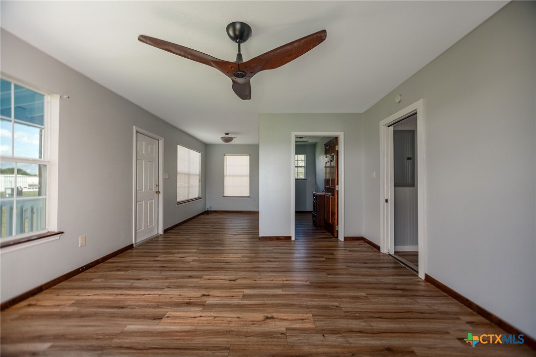 512 McDowell Street Austwell, TX 77950 - Photo 19 of 30 a view of an empty room with wooden floor and a window