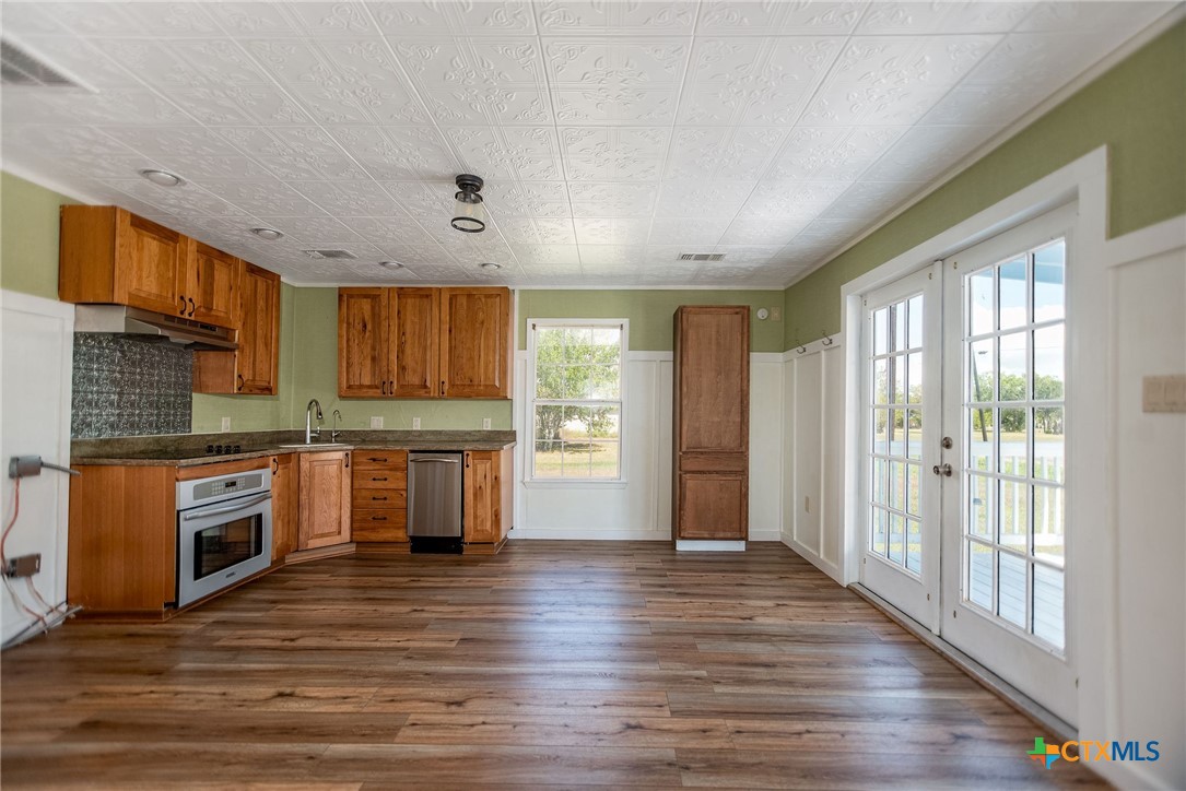 512 McDowell Street Austwell, TX 77950 - Photo 6 of 30 a kitchen with stainless steel appliances granite countertop a stove a sink and a refrigerator