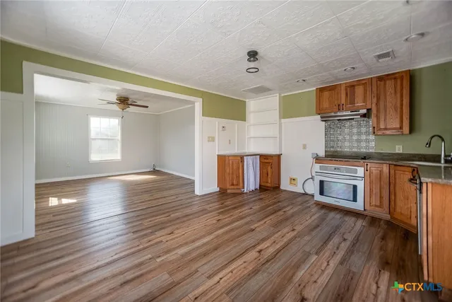 a kitchen with stainless steel appliances granite countertop wooden cabinets a sink and dishwasher