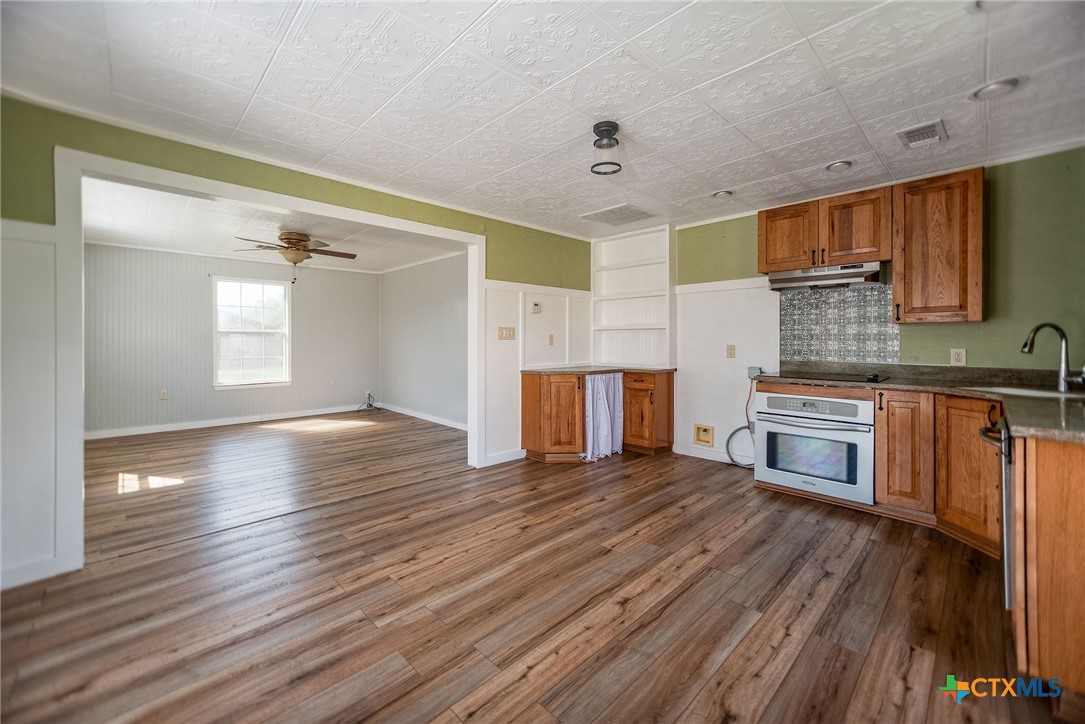 512 McDowell Street Austwell, TX 77950 - Photo 7 of 30 a kitchen with stainless steel appliances granite countertop a stove top oven and sink