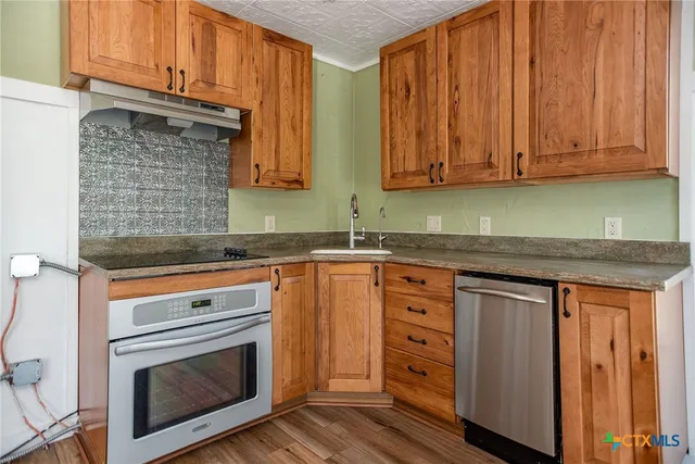 a view of an empty room and wooden floor