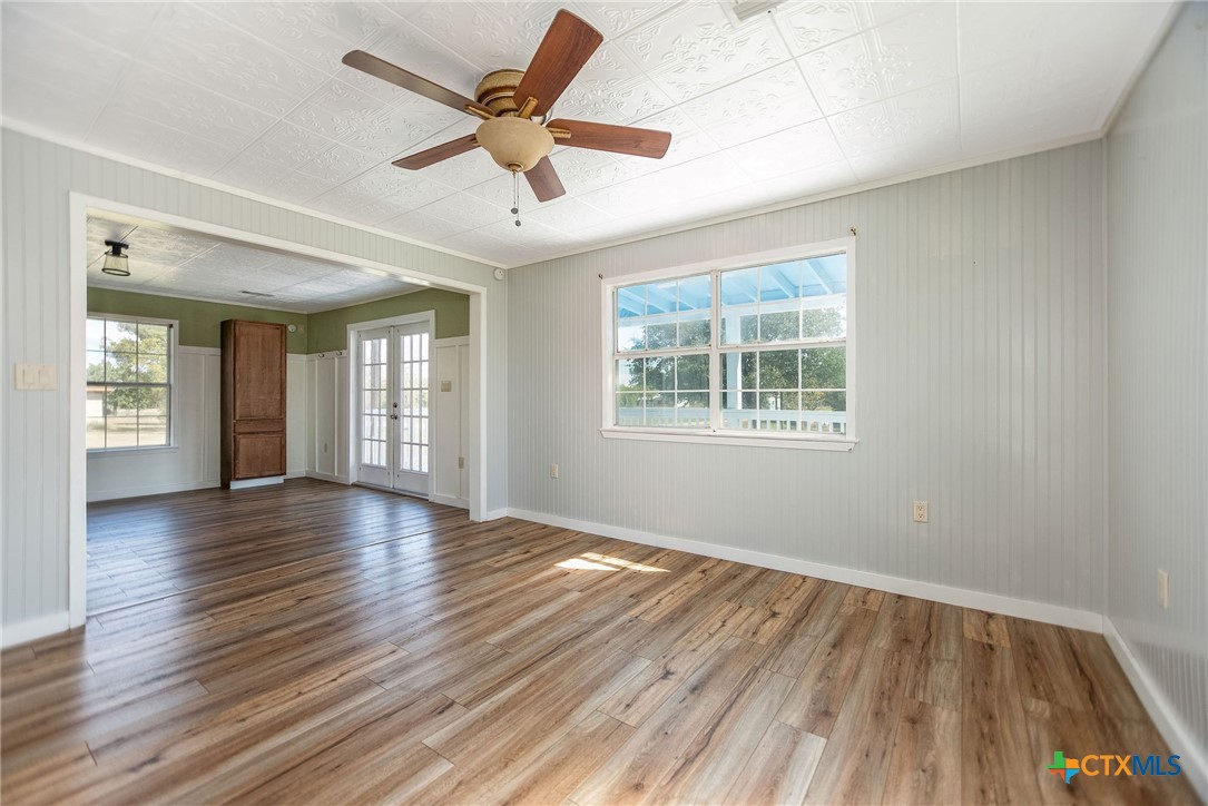 512 McDowell Street Austwell, TX 77950 - Photo 10 of 30 a view of an empty room with wooden floor and a window