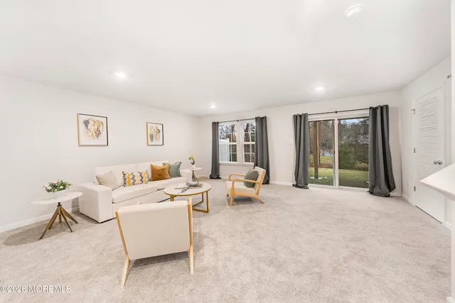 a living room with furniture and large window
