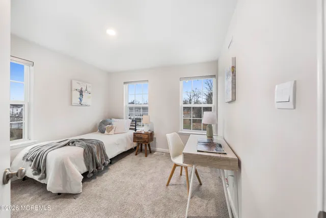a living room with a bed furniture and a window