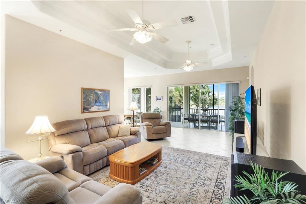 8771 Coastline Court, Unit 201 Naples, FL 34120 - Photo 11 of 49 a living room with furniture and a large window