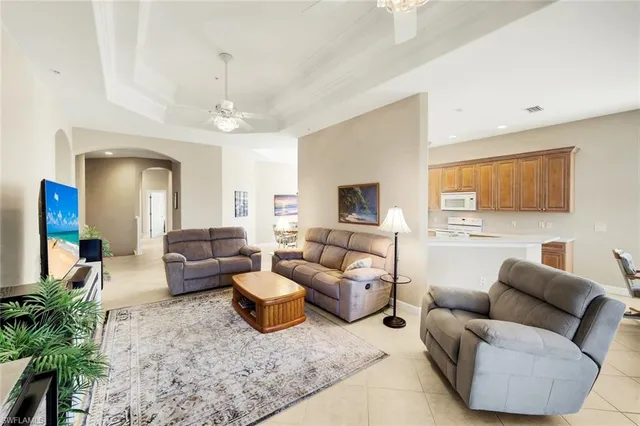 a living room with furniture and a chandelier