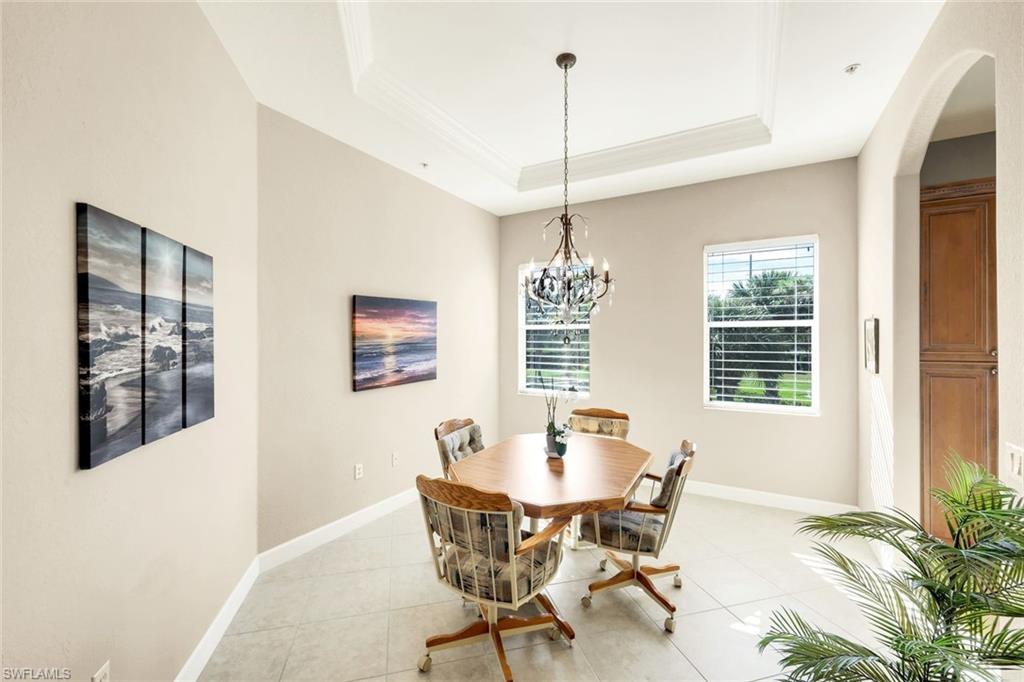 8771 Coastline Court, Unit 201 Naples, FL 34120 - Photo 13 of 49 a view of a dining room with furniture window and outside view