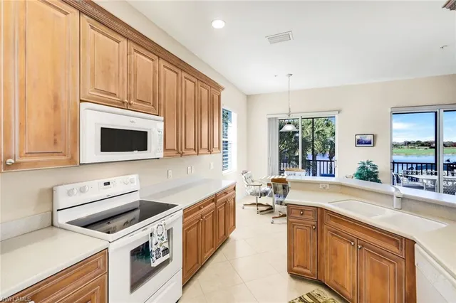 a kitchen with a sink stove and microwave