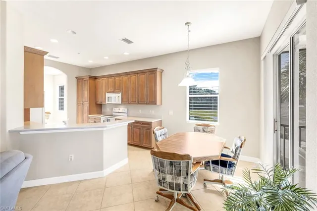 a kitchen with granite countertop sink table and chairs
