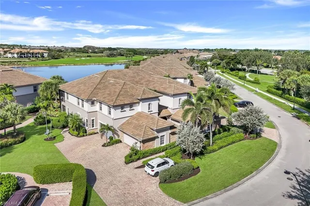 an aerial view of residential houses with outdoor space and street view