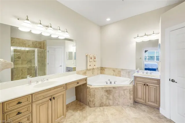 a spacious bathroom with a bathtub sink and mirror