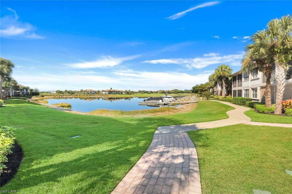 8771 Coastline Court, Unit 201 Naples, FL 34120 - Photo 32 of 49 a view of a lake with houses in the back