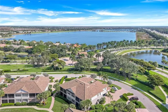 an aerial view of a house with a garden and lake view