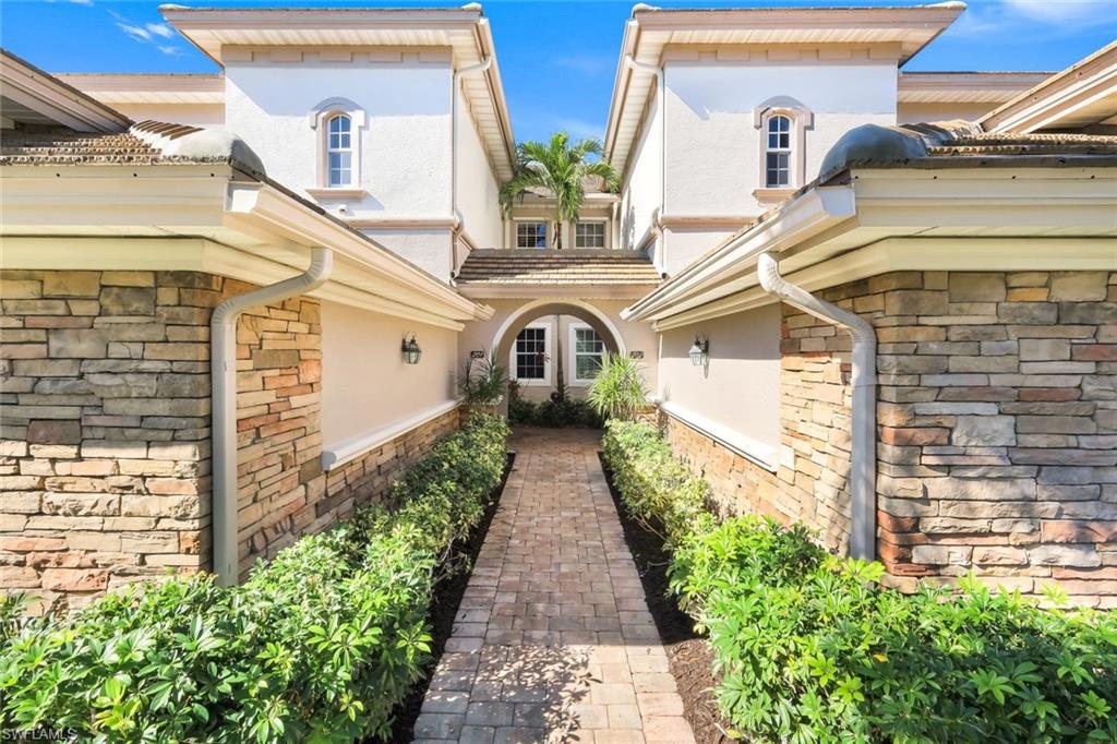 8771 Coastline Court, Unit 201 Naples, FL 34120 - Photo 5 of 49 a view of a pathway with a white house
