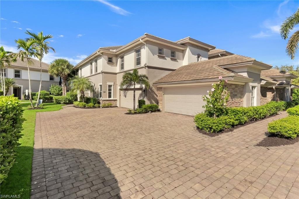 8771 Coastline Court, Unit 201 Naples, FL 34120 - Photo 6 of 49 a front view of a house with a yard