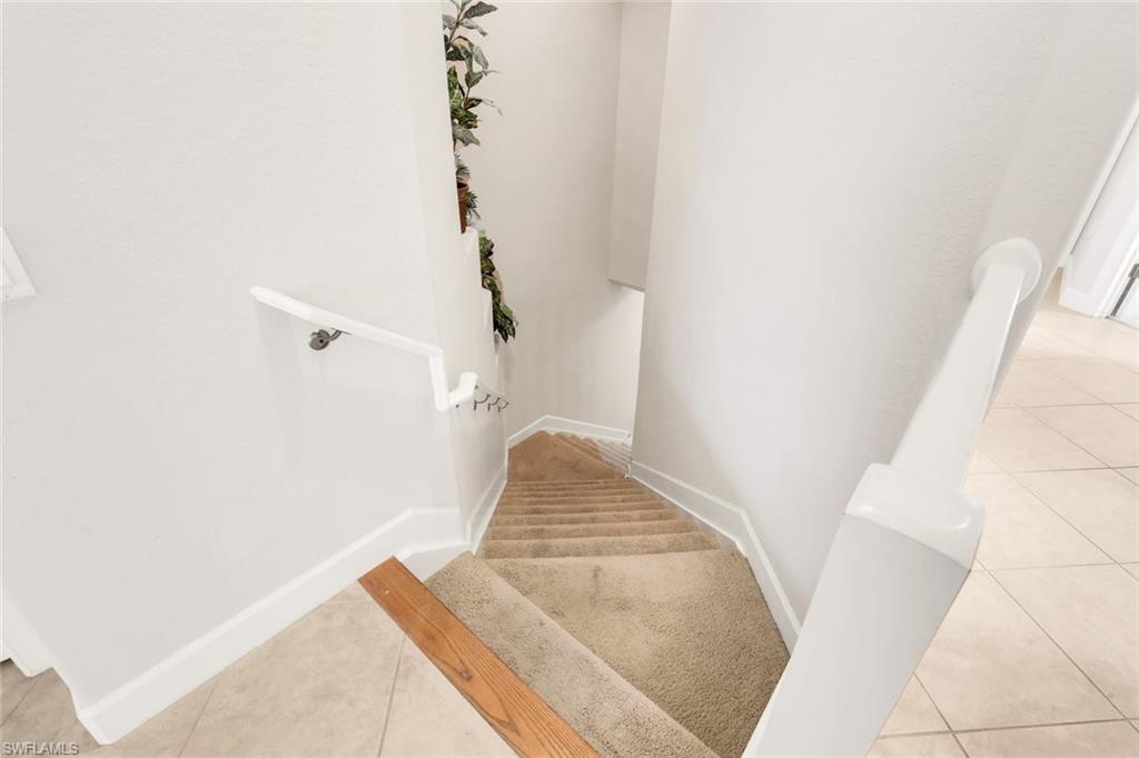 8771 Coastline Court, Unit 201 Naples, FL 34120 - Photo 8 of 49 a view of staircase with white walls