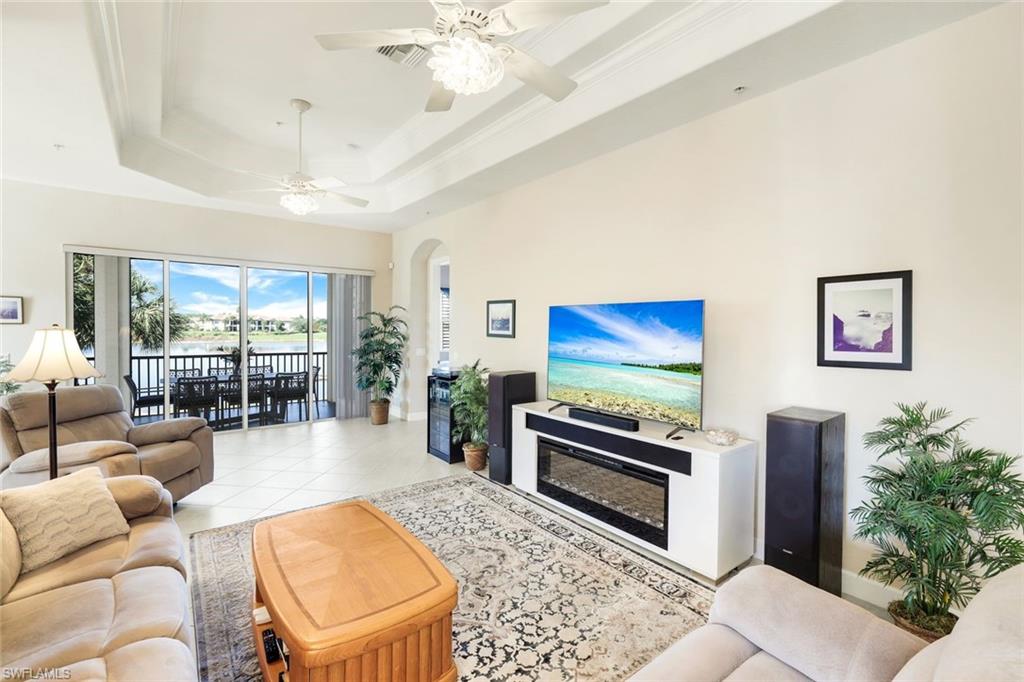 8771 Coastline Court, Unit 201 Naples, FL 34120 - Photo 10 of 49 a living room with furniture and a flat screen tv