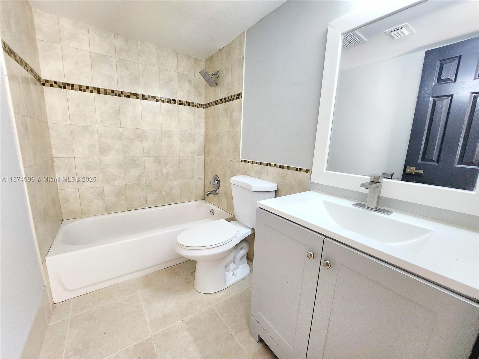 191 Southwest 15th Street, Unit 201 Pompano Beach, FL 33060 - Photo 7 of 10 a bathroom with a sink a toilet and a bathtub