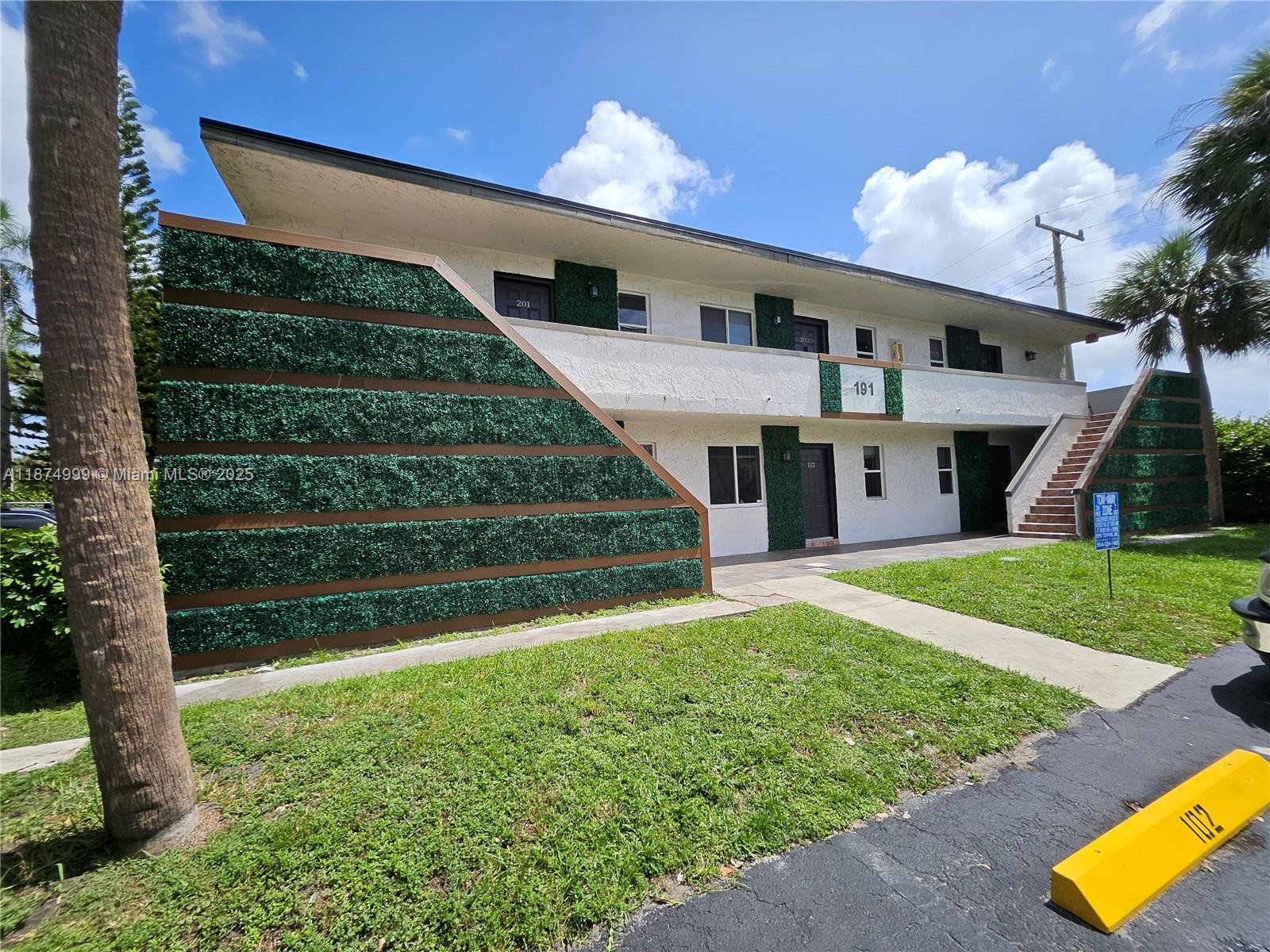 191 Southwest 15th Street, Unit 201 Pompano Beach, FL 33060 - Photo 10 of 10 a front view of house with yard