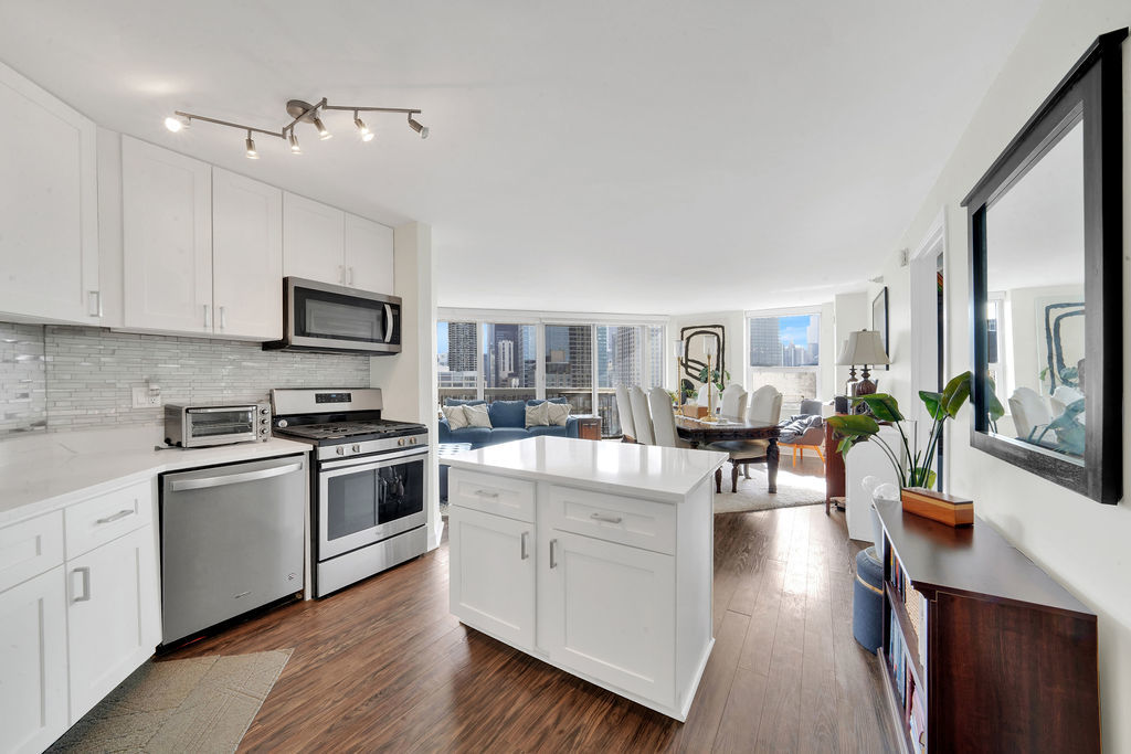545 North Dearborn Street, Unit 2510 Chicago, IL 60654 - Photo 2 of 37 a kitchen with stainless steel appliances granite countertop a refrigerator a stove top oven a sink dishwasher and white cabinets with wooden floor