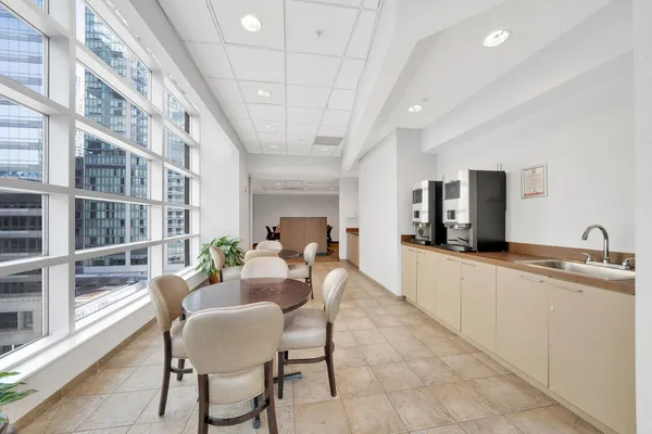 a large living room with stainless steel appliances kitchen island granite countertop furniture and a kitchen view