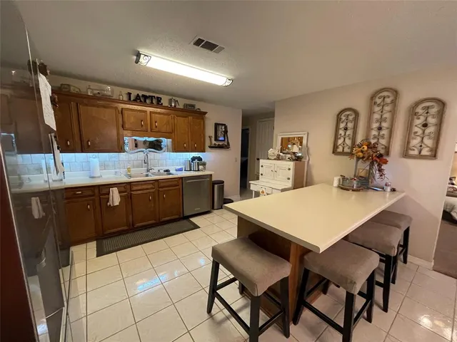 a kitchen with a table and chairs in it