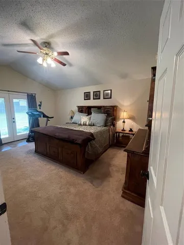 a bedroom with a bed window and couch