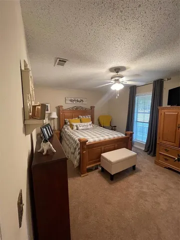 a bedroom with bed and window