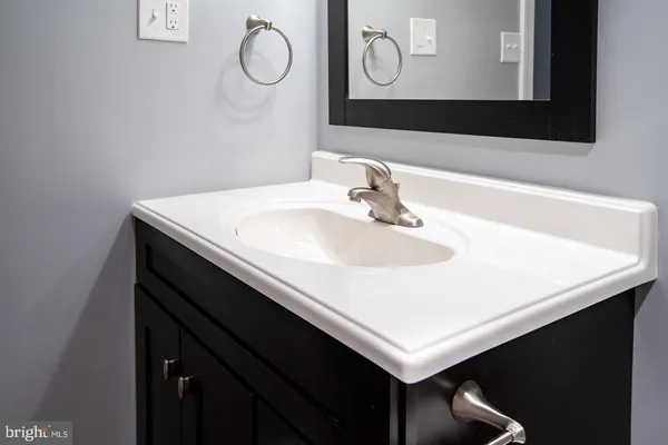 a bathroom with a sink vanity and a mirror