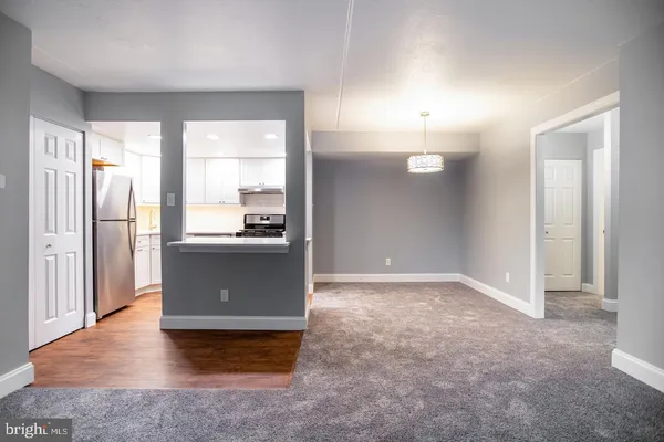 a view of a kitchen with a refrigerator and a sink