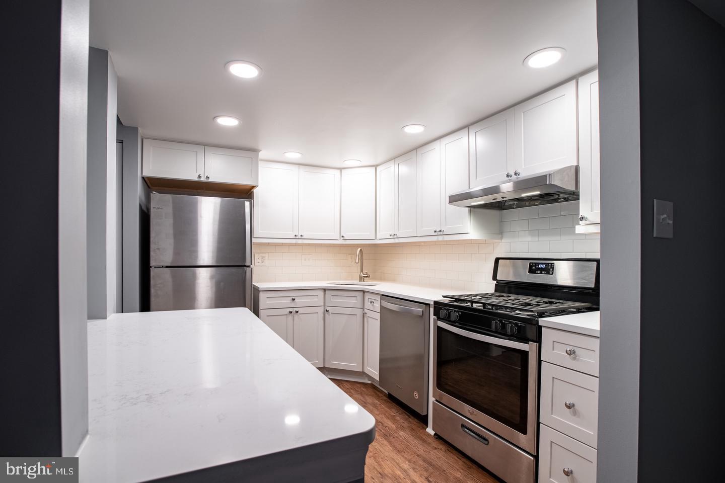 188 Old Forge Crossing, Unit 188 Devon, PA 19333 - Photo 8 of 19 a kitchen with stainless steel appliances a stove a sink and a refrigerator