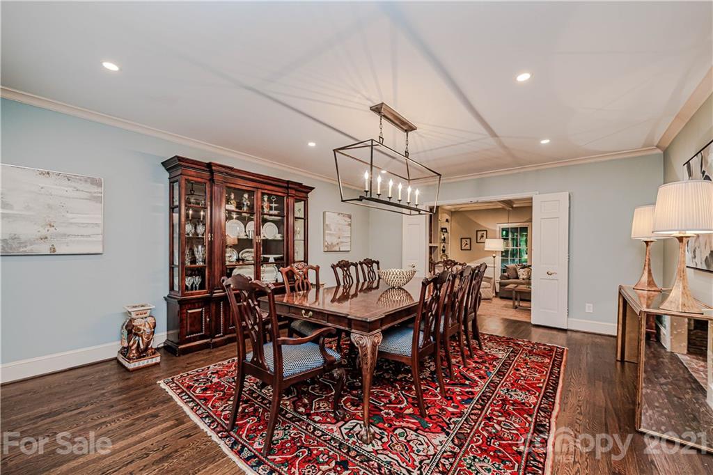 3800 River Ridge Road Charlotte, NC 28226 - Photo 16 of 48 a dining room with wooden floor a chandelier a wooden table and chairs