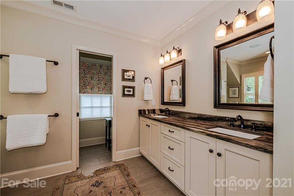 3800 River Ridge Road Charlotte, NC 28226 - Photo 20 of 48 a spacious bathroom with a granite countertop sink and a mirror