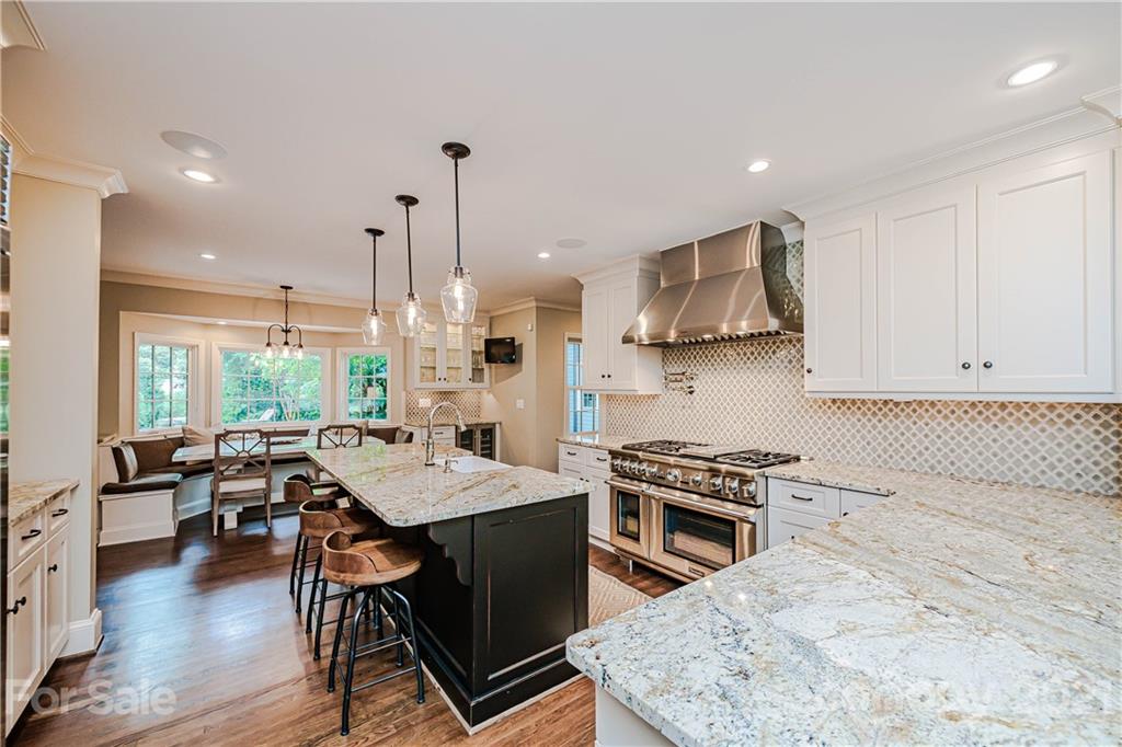 3800 River Ridge Road Charlotte, NC 28226 - Photo 7 of 48 a kitchen with stainless steel appliances granite countertop a stove a sink dishwasher and a refrigerator with wooden floor