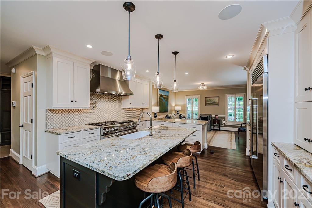 3800 River Ridge Road Charlotte, NC 28226 - Photo 8 of 48 a kitchen with granite countertop kitchen island stainless steel appliances a stove center island a table and chairs