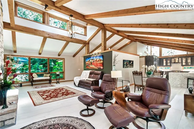 a living room with furniture and a floor to ceiling window