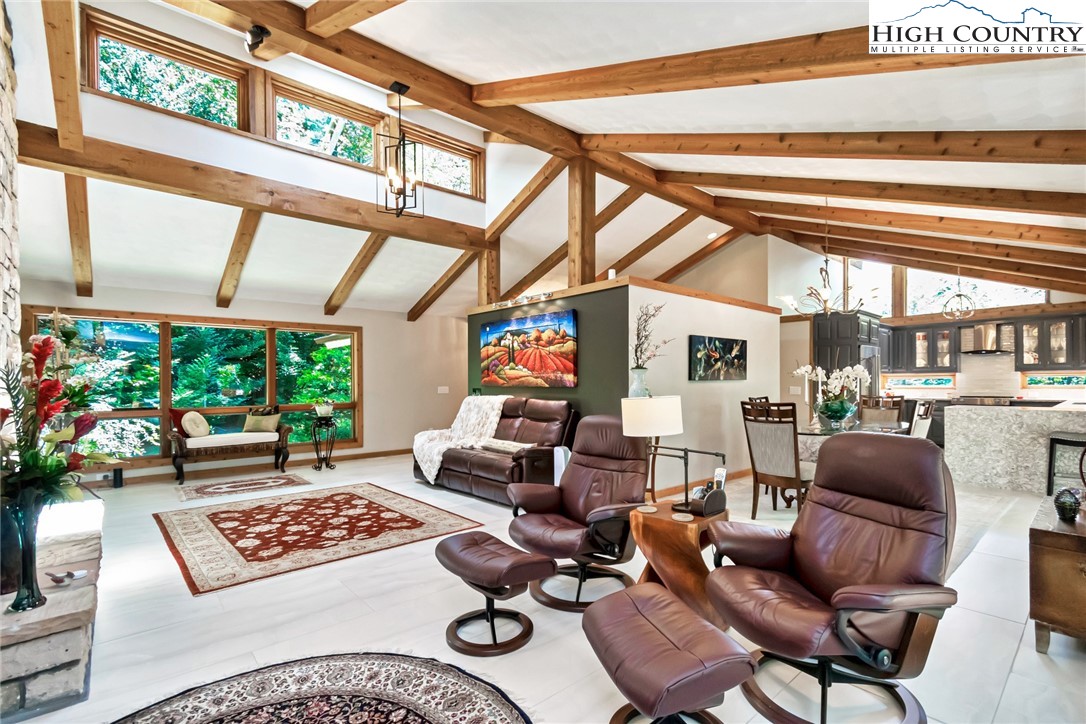 a living room with furniture and a floor to ceiling window