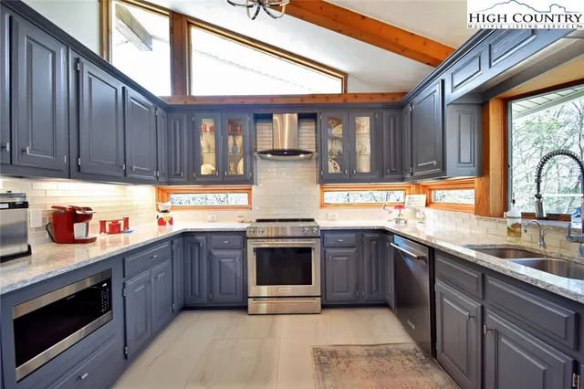 a kitchen with stainless steel appliances granite countertop a stove and a sink