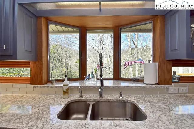 a kitchen with a sink and a large window