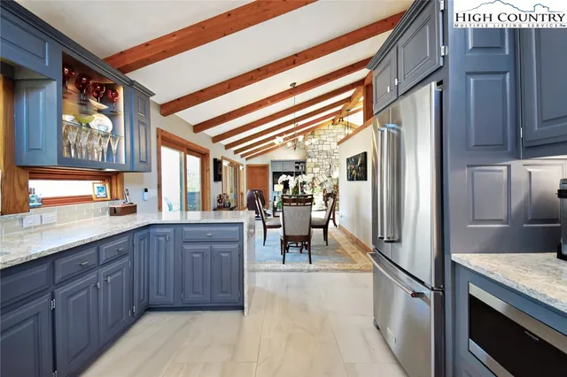 a kitchen with granite countertop lots of counter top space and stainless steel appliances