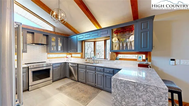 a kitchen with stainless steel appliances granite countertop a stove and a sink