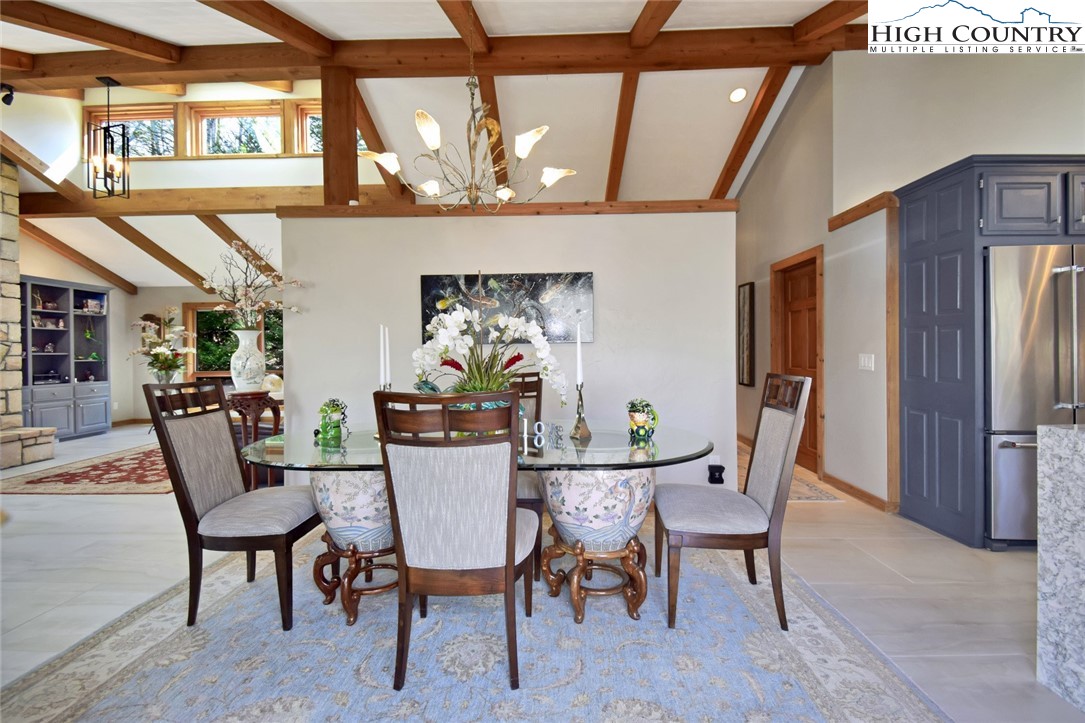 505 Tanglewood Cemetery Road Linville, NC 28646 - Photo 22 of 47 a view of a dining room with furniture a chandelier and wooden floor