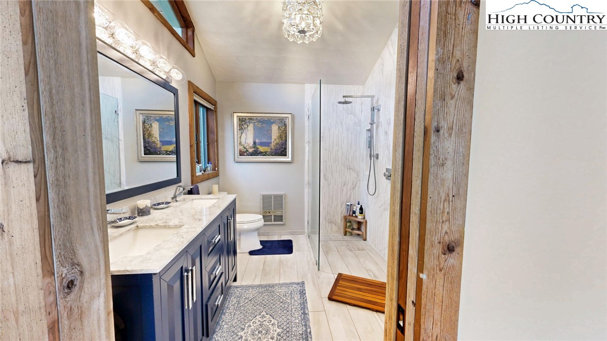 505 Tanglewood Cemetery Road Linville, NC 28646 - Photo 29 of 47 a bathroom with a sink a mirror and a shower