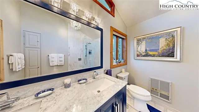 a bathroom with a sink a toilet and mirror