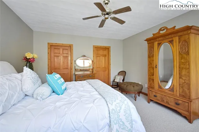 a bedroom with bed and wooden floor