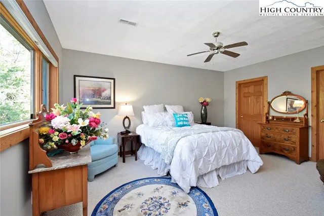 a bedroom with bed and a window