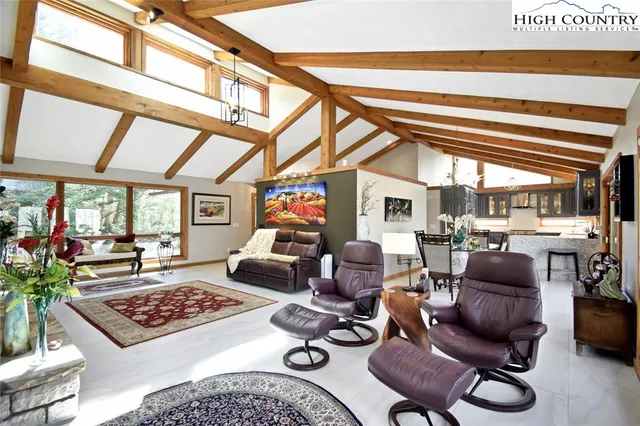 a living room with furniture a rug and a large window