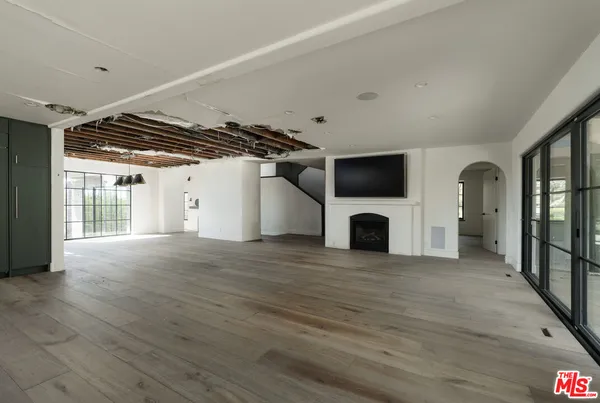 a view of a livingroom with a fireplace and a window