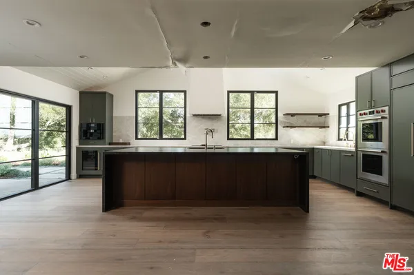 a kitchen with a stove a sink and a refrigerator